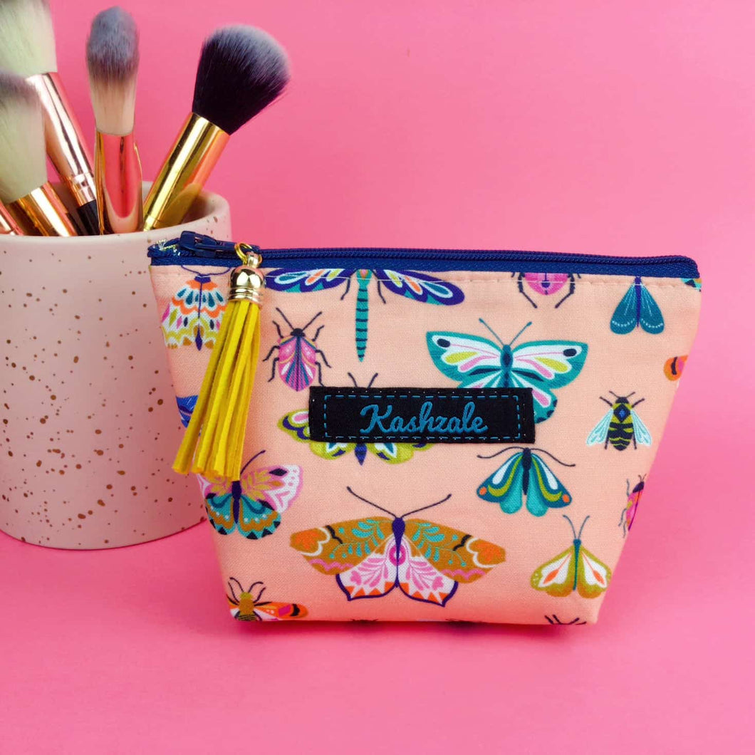 Coral Bugs and Butterflies Small Makeup Bag.